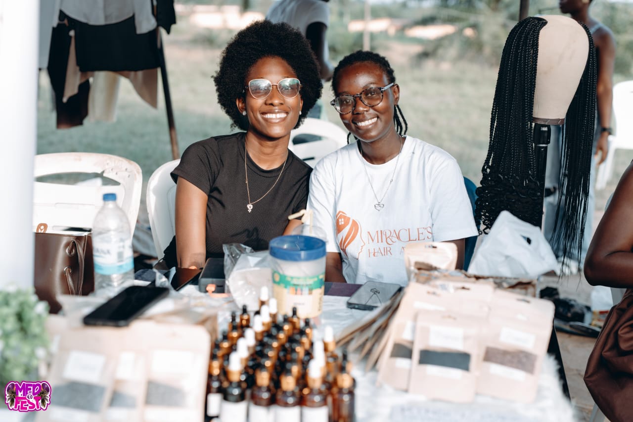 Vendors smiling behind an accessories stall